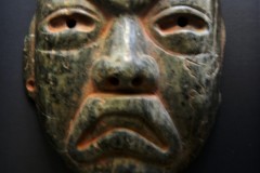 Olmec: maskette green serpentine, with traces of cinnabar powder from the region of Veracruz, Gulf  Coast,    Mexico, Late Classic circa 300-150 B.C. Measurements  9cm x 8 cm